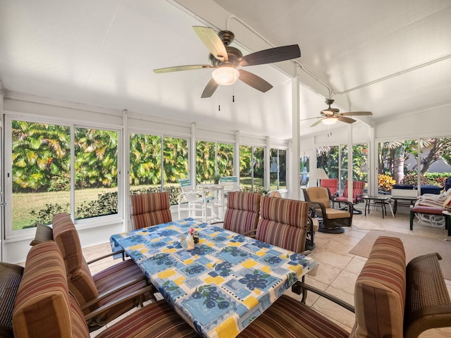 sunroom featuring lofted ceiling, ceiling fan, and plenty of natural light