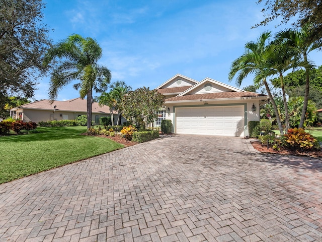 view of front of property featuring a front lawn and a garage