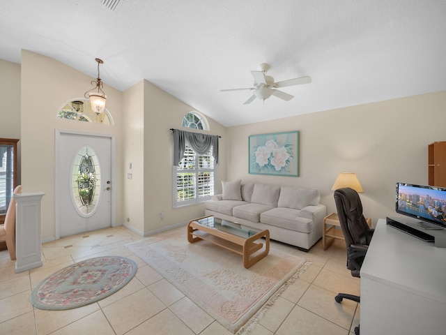 living room with lofted ceiling, ceiling fan, and light tile patterned floors