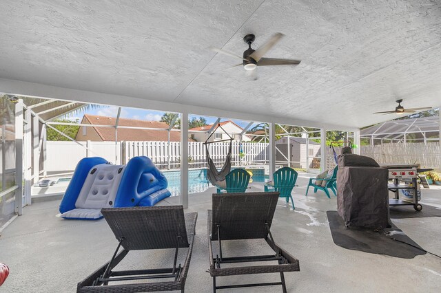 view of swimming pool featuring a patio area, a lanai, and an outdoor fire pit