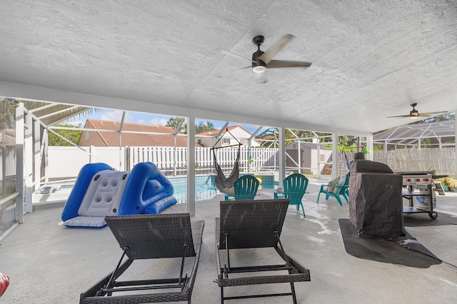 view of patio with a shed, a fenced in pool, a lanai, and ceiling fan