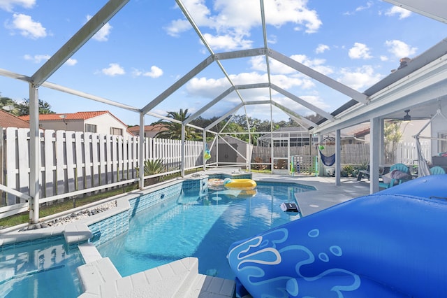 view of swimming pool with a lanai and a patio area