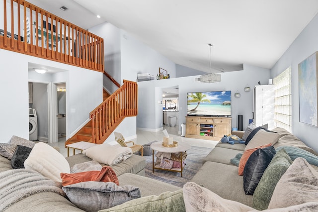 living room with high vaulted ceiling and washer / clothes dryer