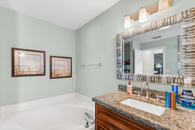 bathroom featuring a washtub and vanity