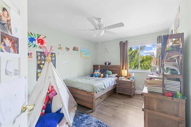 bedroom with ceiling fan and light hardwood / wood-style flooring