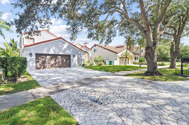 mediterranean / spanish-style house with a front lawn and a garage