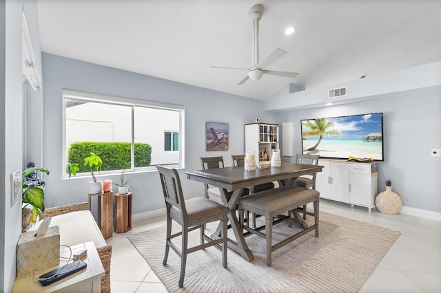 tiled dining room with vaulted ceiling and ceiling fan