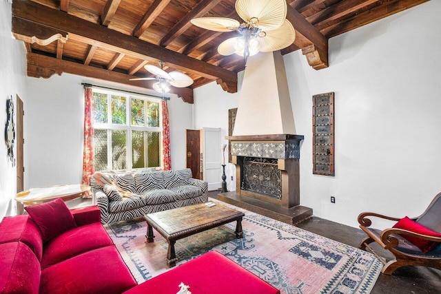 living room with beam ceiling, a premium fireplace, wood ceiling, and ceiling fan