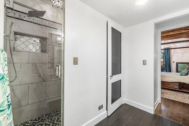 bathroom featuring a stall shower, ensuite bath, baseboards, and wood finished floors