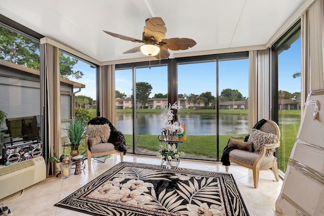 sunroom with a water view and ceiling fan