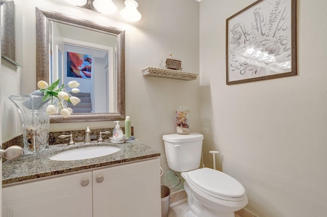 bathroom with toilet and vanity