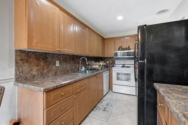 kitchen with sink, light tile patterned floors, backsplash, and white appliances