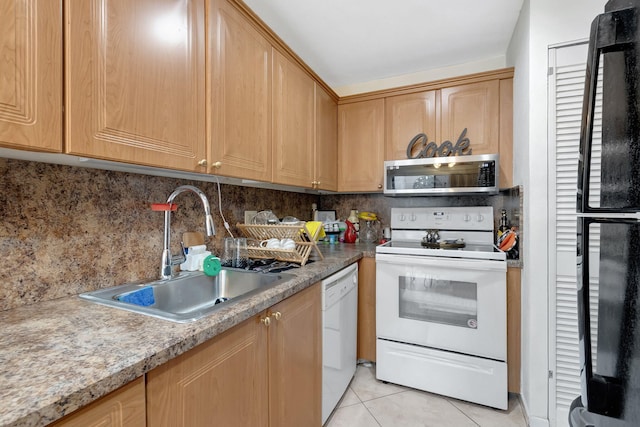 kitchen with white appliances, backsplash, light tile patterned flooring, and sink