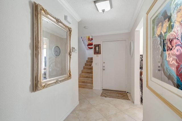 interior space with ornamental molding, a textured ceiling, and light tile patterned floors