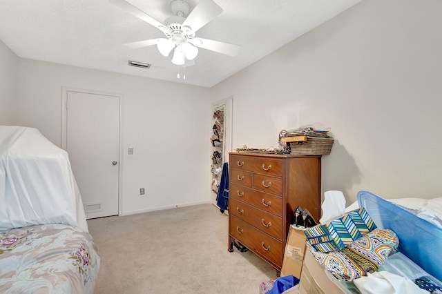 bedroom featuring light colored carpet and ceiling fan