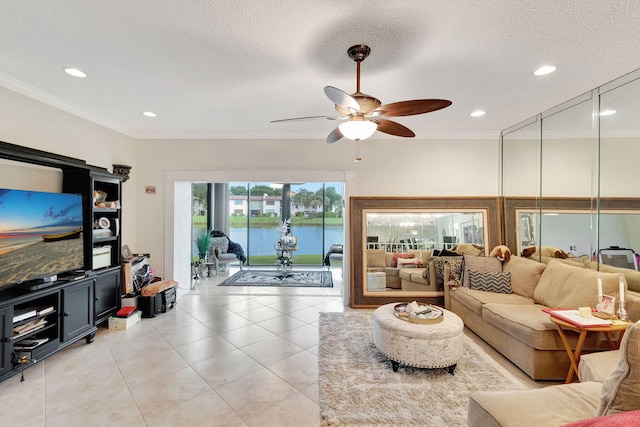 tiled living room featuring crown molding, a textured ceiling, a water view, and ceiling fan