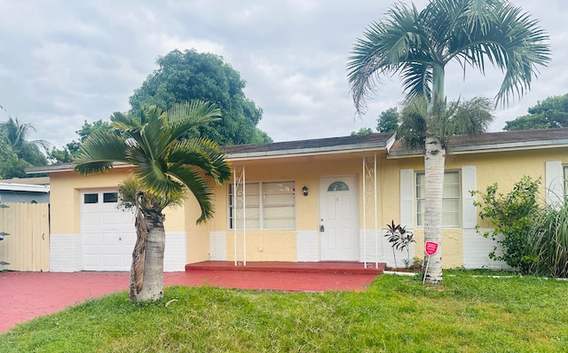 single story home with a garage and a front yard