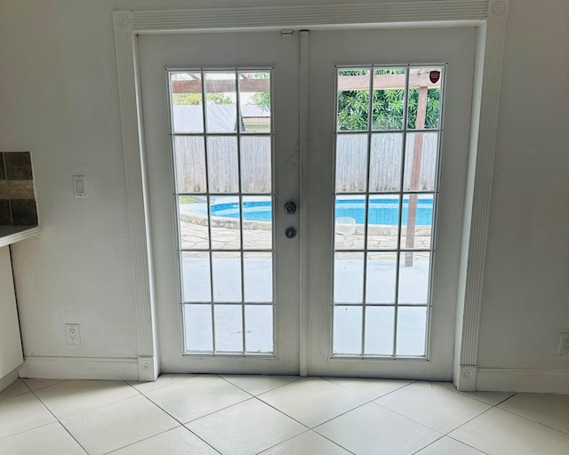 doorway to outside featuring light tile patterned floors and french doors