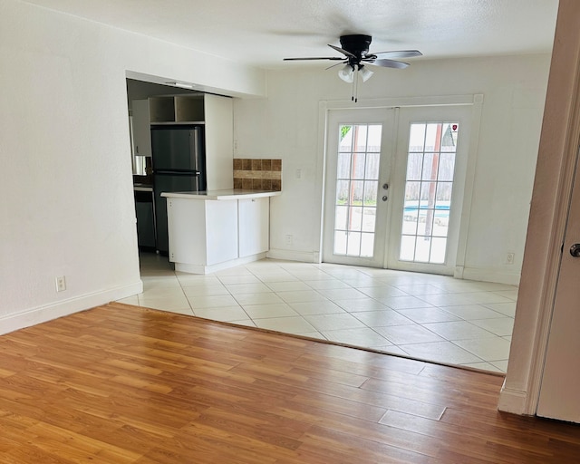 interior space featuring french doors, a textured ceiling, light hardwood / wood-style floors, and ceiling fan