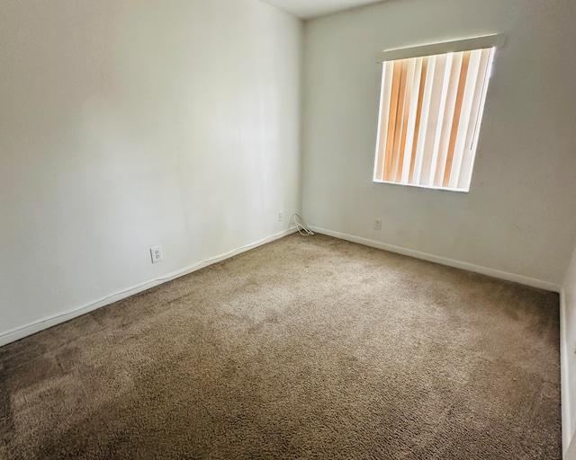 unfurnished room featuring carpet flooring