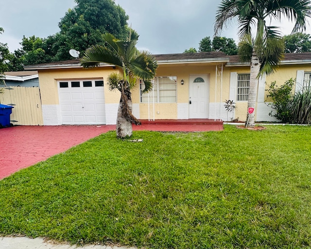 single story home featuring a front yard and a garage