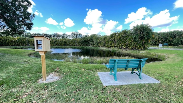 view of community featuring a water view and a lawn