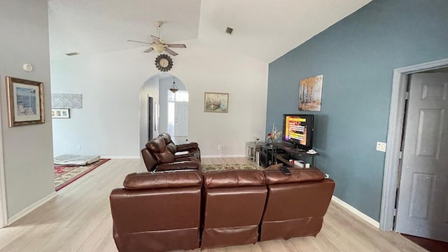 living room with ceiling fan, light hardwood / wood-style flooring, and high vaulted ceiling