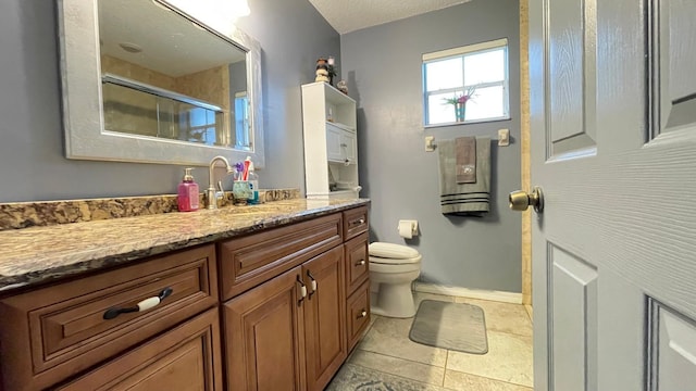 bathroom featuring tile patterned flooring, vanity, toilet, and a shower with shower door