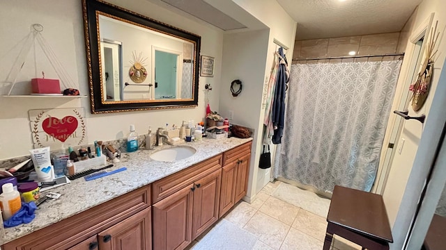 bathroom with tile patterned floors, vanity, a textured ceiling, and a shower with shower curtain