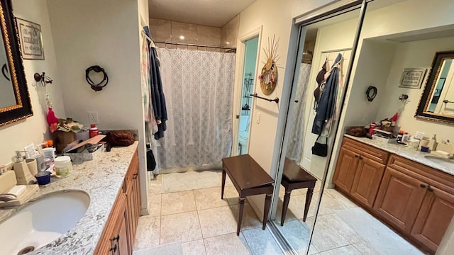 bathroom featuring tile patterned flooring, vanity, and a shower with shower curtain