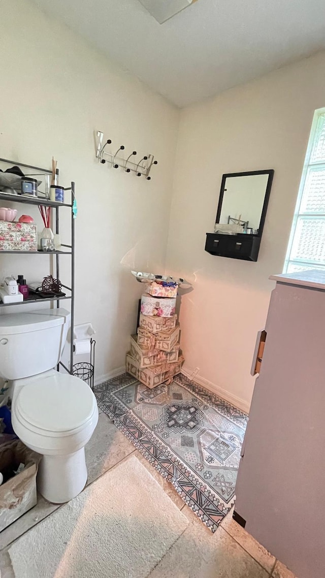 bathroom with toilet and tile patterned flooring