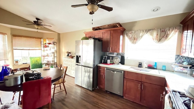 kitchen with stainless steel appliances, tasteful backsplash, ceiling fan, dark wood-type flooring, and vaulted ceiling