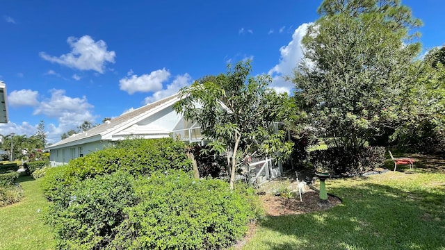 view of side of home with a yard