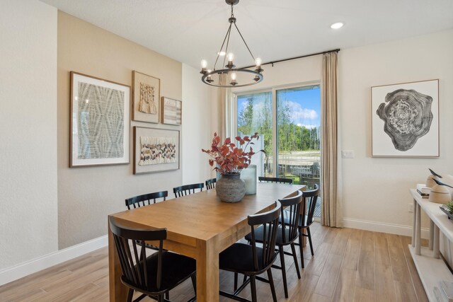 dining room featuring a chandelier and light wood-type flooring