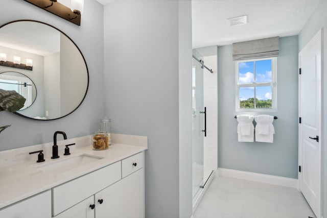 bathroom with vanity, a textured ceiling, and an enclosed shower