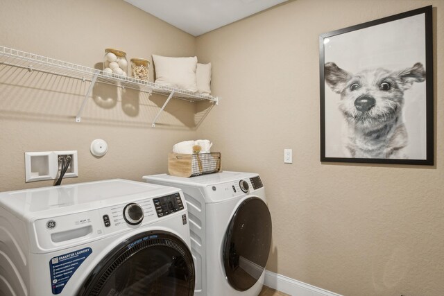 clothes washing area featuring washer and dryer