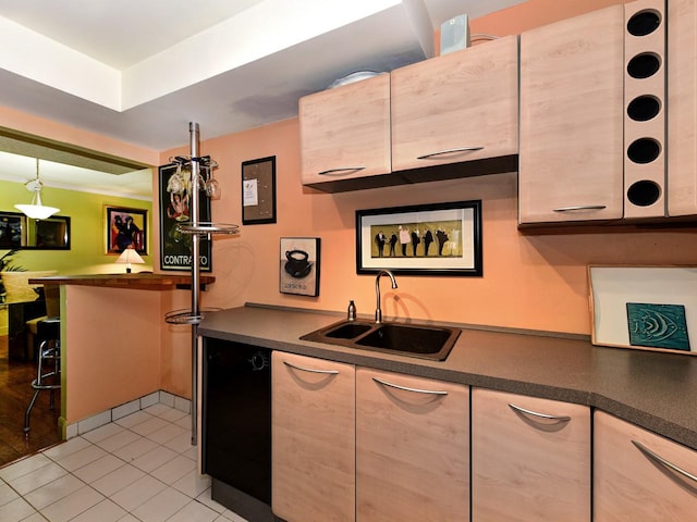 kitchen featuring dishwasher, sink, and light tile patterned floors