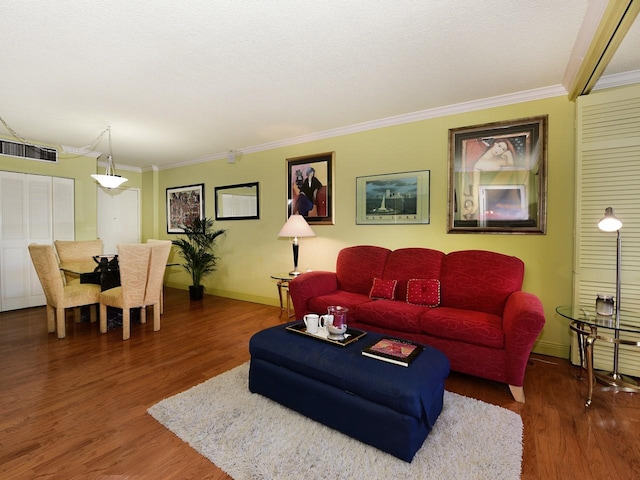 living room with ornamental molding, a textured ceiling, and dark hardwood / wood-style flooring