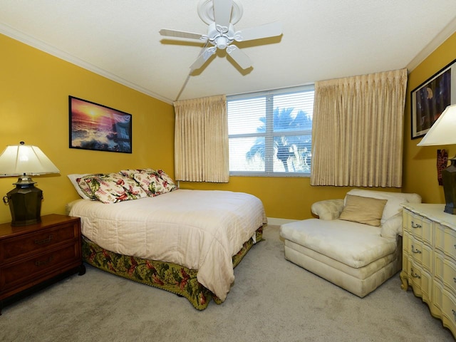 carpeted bedroom featuring ornamental molding and ceiling fan