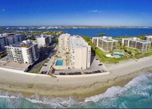 drone / aerial view with a water view and a view of the beach