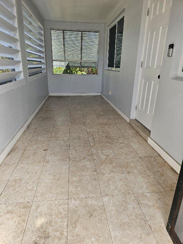 unfurnished room featuring baseboards