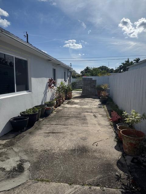 exterior space with a fenced backyard and stucco siding