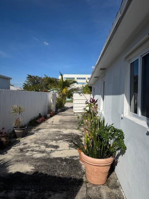 view of home's exterior with fence and stucco siding