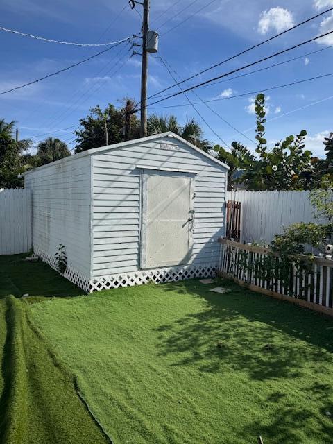 view of shed with fence