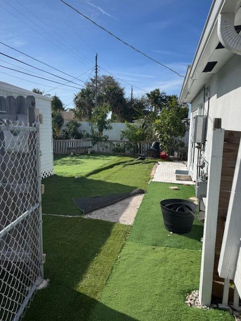 view of yard with fence and a patio