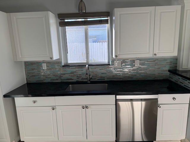 kitchen featuring a sink, dark countertops, white cabinets, and dishwasher