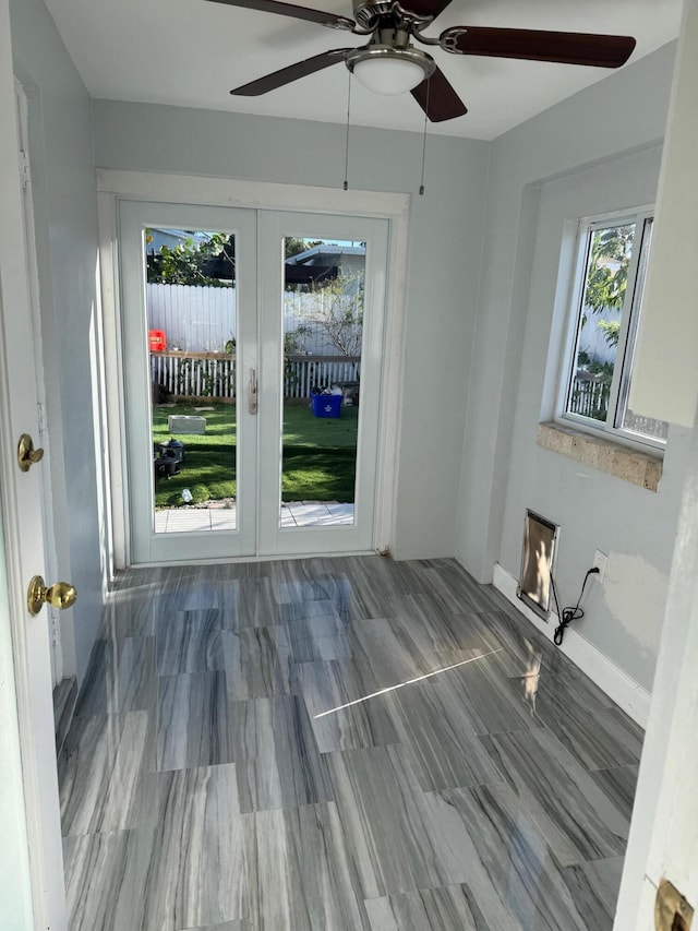 unfurnished room featuring french doors and baseboards