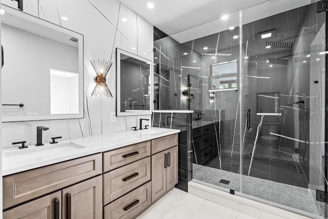 bathroom with vanity, tile patterned flooring, backsplash, and a shower with door