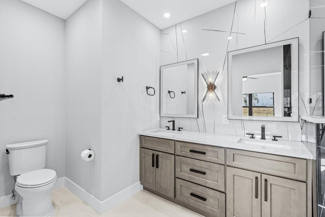 bathroom featuring toilet, ceiling fan, vanity, and tile patterned flooring