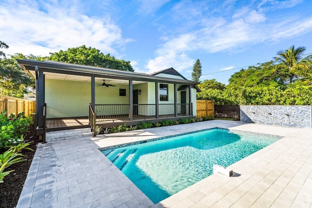 back of property featuring a fenced in pool, a patio area, and ceiling fan